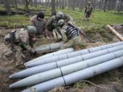 FILE - Ukrainian soldiers collect multiple Russian 'Uragan' missiles after recent fights in the village of Berezivka, Ukraine, April 21, 2022. A majority of U.S. adults say misinformation around Russia's invasion of Ukraine is a major problem, and they largely fault the Russian government for spreading those falsehoods. A new poll from The Associated Press-NORC Center for Public Affairs Research shows 61% of Americans say the spread of misinformation about the war is a major problem, with only 7% saying it's not a problem.