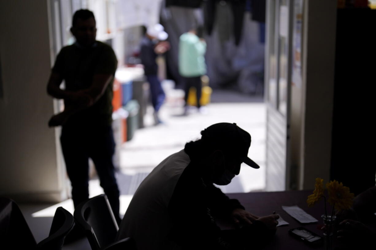 A man from Nicaragua sits at a shelter for migrants Thursday, April 21, 2022, in Tijuana, Mexico. The man is waiting in Mexico for hearings in U.S. immigration court, part of a Trump-era policy that will be argued Tuesday before the U.S. Supreme Court.