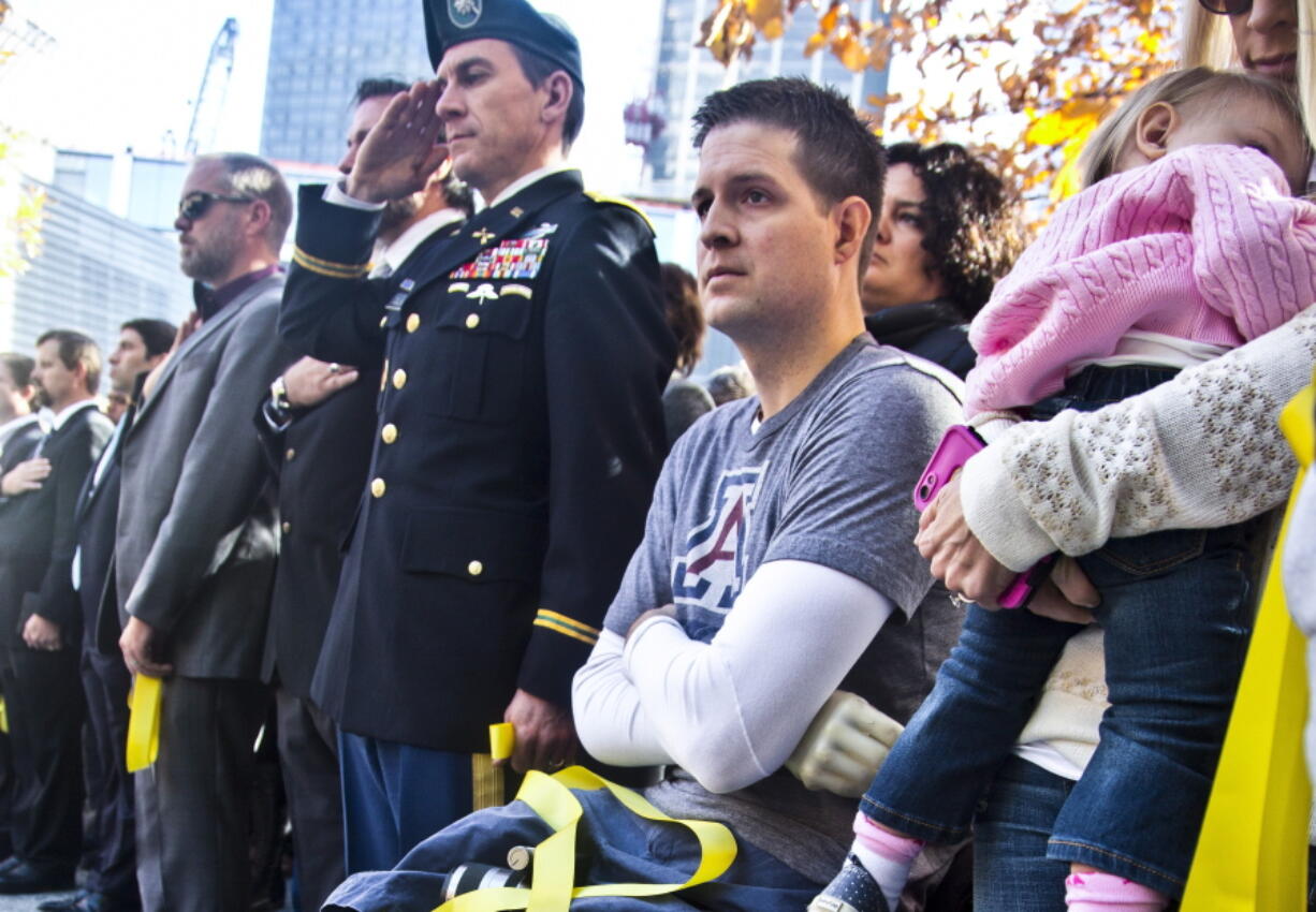 FILE - Former U.S. Air Force veteran and Iraq war double amputee Brian Kolfage, second from right, attends the National September 11 Memorial and Museum's "Salute to Service" tribute honoring U.S. veterans, Nov. 10, 2014 in New York. Kolfage, co-founder of the "We Build The Wall" project aimed at raising money for a border wall, has pleaded guilty, Thursday, April 21, 2022 to charges in a case that once included former President Donald Trump's adviser Steve Bannon.