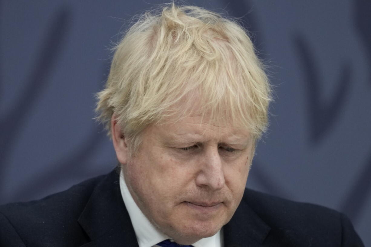 FILE - British Prime Minister Boris Johnson delivers a speech at Lydd Airport, south east England, Thursday, April 14, 2022.  Johnson is facing British lawmakers for the first time since he was fined by police for attending a birthday party in his office that broke coronavirus lockdown rules. As the House of Commons returns Tuesday, April 19, 2022 from an 11-day Easter break, Johnson is expected to apologize for what he insists was a minor slip-up.