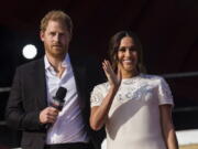 FILE - Prince Harry and his wife Meghan speak during the Global Citizen festival, on Sept. 25, 2021 in New York. Prince Harry and his wife Meghan have visited Queen Elizabeth II at Windsor Castle on their first joint visit to the U.K. since they gave up formal royal roles and moved to the U.S. more than two years ago.