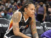 FILE - Phoenix Mercury center Brittney Griner sits during the first half of Game 2 of basketball's WNBA Finals against the Chicago Sky, Wednesday, Oct. 13, 2021, in Phoenix. Griner is easily the most prominent American citizen known to be jailed by a foreign government. Yet as a crucial hearing approaches next month, the case against her remains shrouded in mystery, with little clarity from the Russian prosecutors.