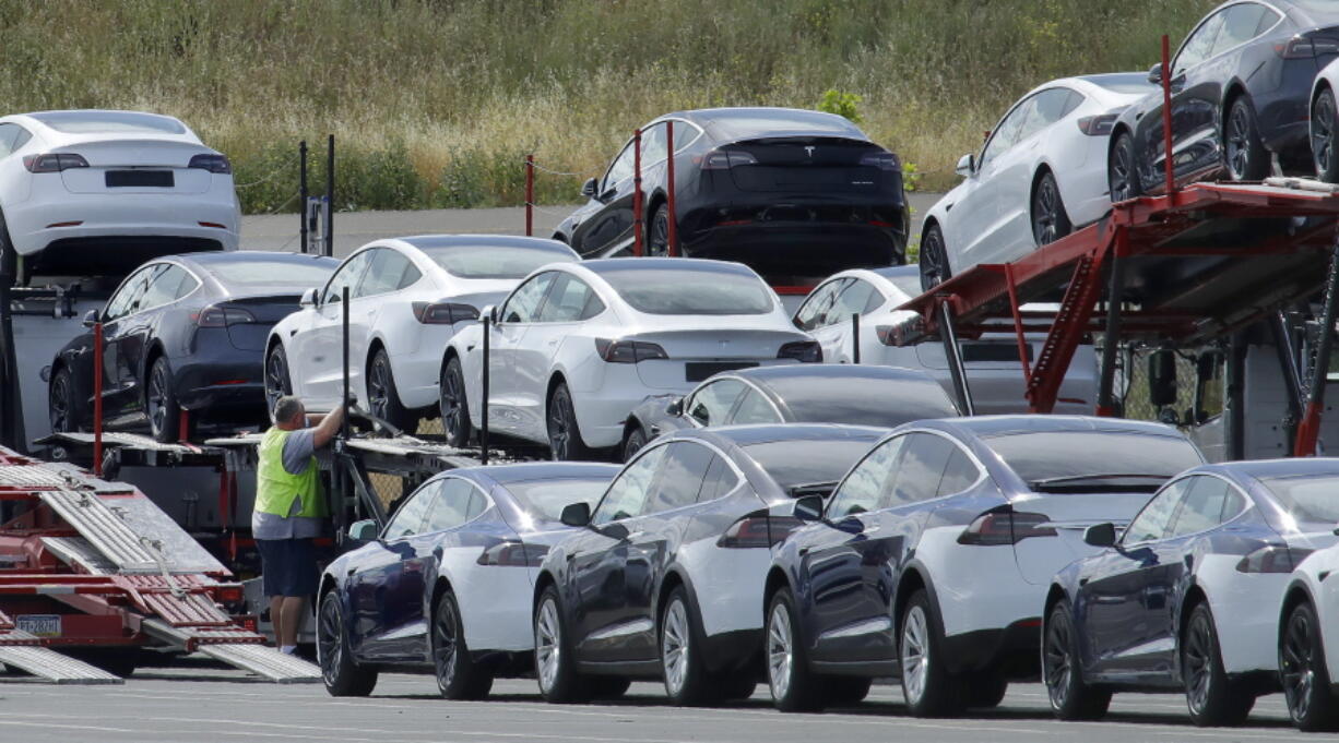 FILE - In this May 13, 2020, file photo, Tesla cars are loaded onto carriers at the Tesla electric car plant in Fremont, Calif. California wants electric vehicle sales to triple in the next four years to 35% of all new car purchases. Regulations passed Tuesday, April 12, 2022 by the California Air Resources Board set a roadmap for the state to achieve California Gov. Gavin Newsom's ambitious goal of phasing out the sale of new gas powered cars. The draft must go through a months-long state regulatory process and get approval from the U.S. EPA.