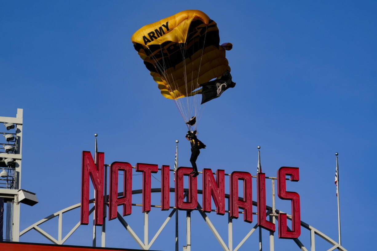 The U.S. Army Parachute Team the Golden Knights descend into National Park before a baseball game between the Washington Nationals and the Arizona Diamondbacks Wednesday, April 20, 2022, in Washington. The U.S. Capitol was briefly evacuated after police said they were tracking an aircraft "that poses a probable threat," but the plane turned out to be the military aircraft with people parachuting out of it for a demonstration at the Nationals game, officials told The Associated Press.