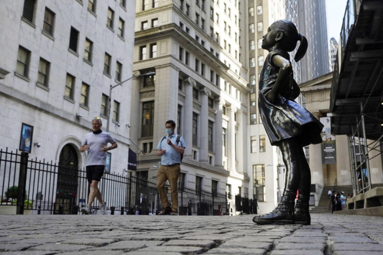 The Fearless Girl statue faces the New York Stock Exchange.