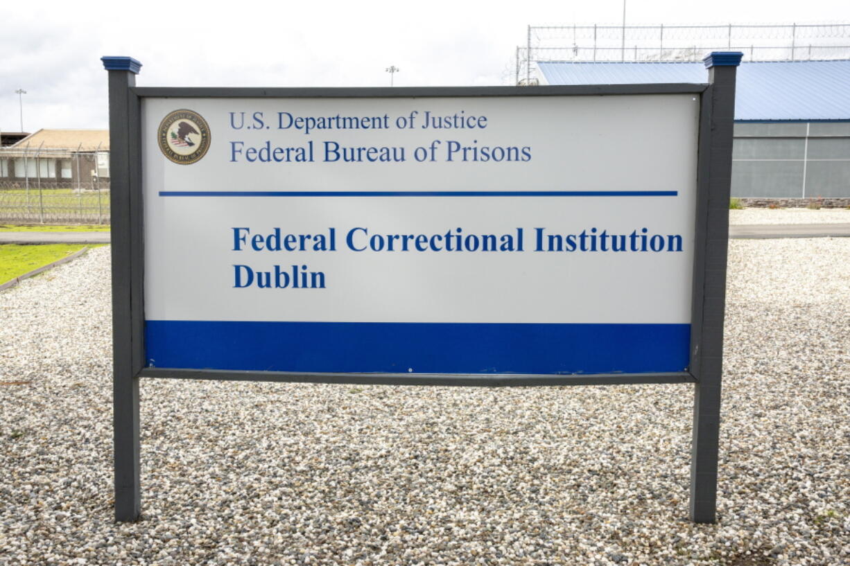 FILE - A sign for the Federal Correctional Institution Dublin is displayed on Jan. 9, 2019, in Dublin, Calif. A government watchdog has found a "substantial likelihood" the federal Bureau of Prisons committed wrongdoing when it ignored complaints and failed to address asbestos and mold contamination at the federal women's prison that has already been under scrutiny for rampant sexual abuse of inmates.