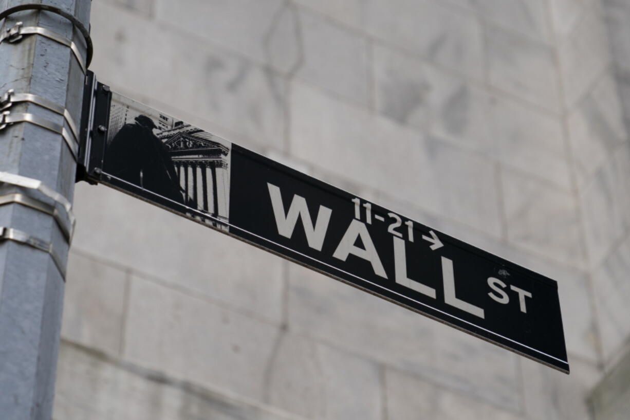 FILE - A Wall Street sign is shown in the Financial District, Wednesday, Oct. 13, 2021, in the Manhattan borough of New York.  Stocks are opening lower on Wall Street again, and big technology companies were leading the way lower ahead of a busy week of earnings reports from several of them. Microsoft and Google's parent company, Alphabet, were among the bigger weights on the market in early trading Tuesday, April 26, 2022.