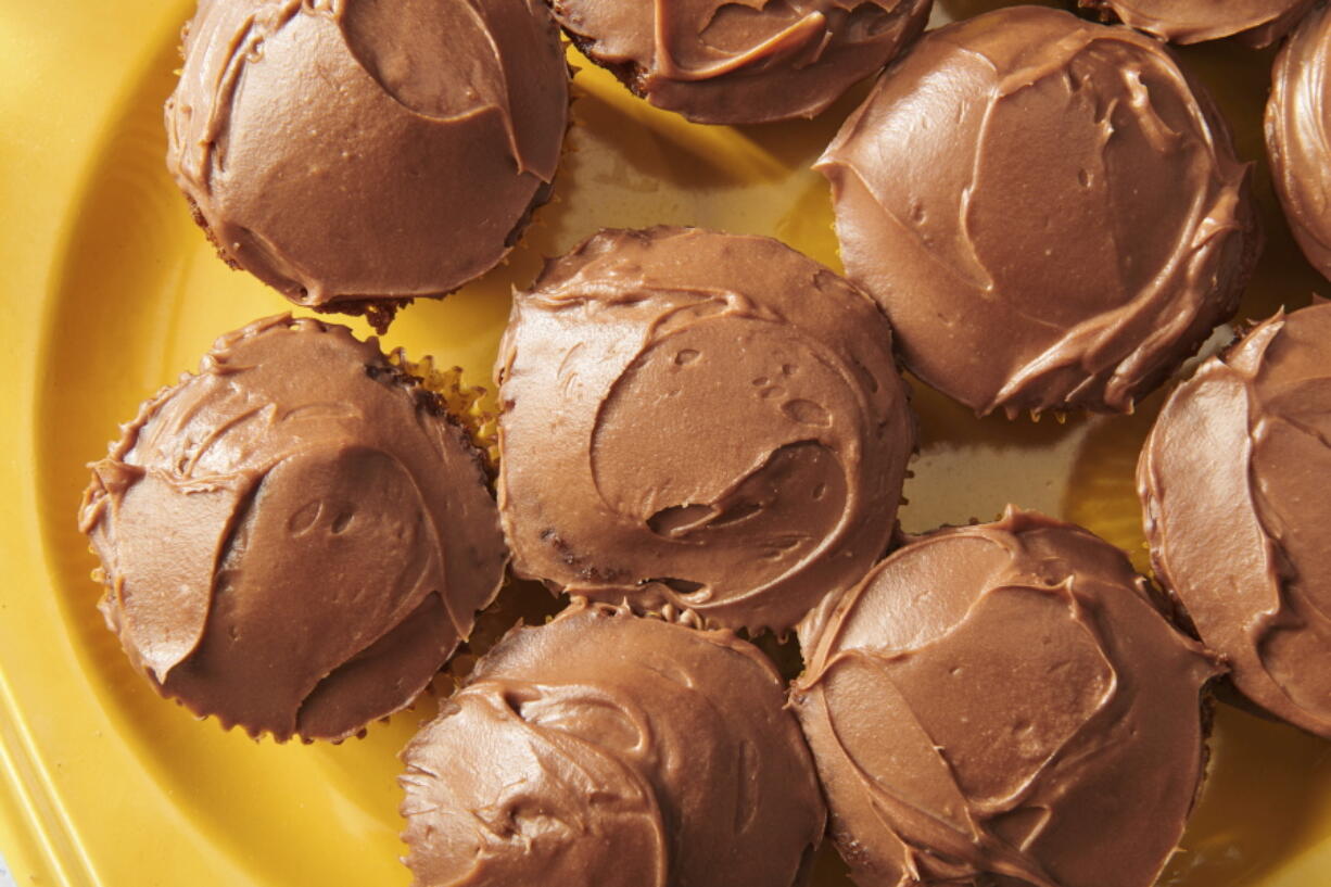 This image shows a plate of carrot cupcakes with cream cheese chocolate frosting in New York in March 2022.