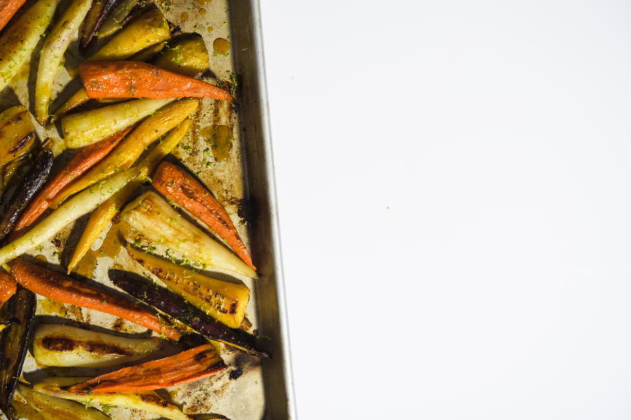 This image released by Milk Street shows a recipe for roasted carrots with the turmeric-infused honey.