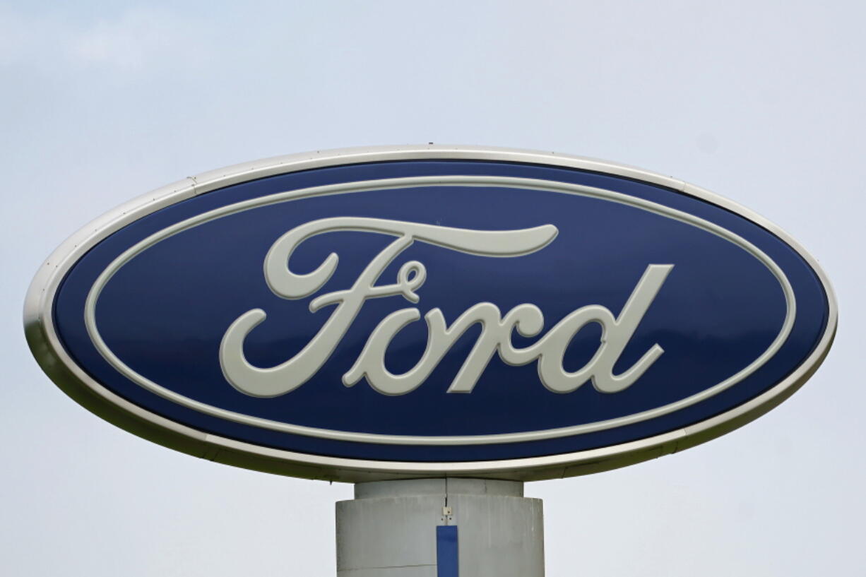 FILE - A Ford logo is seen on signage at Country Ford in Graham, N.C., Tuesday, July 27, 2021.  Ford is issuing two recalls covering over 737,000 vehicles, Friday, April 1, 2022, to fix oil leaks and trailer braking systems that won't work. The oil leak recall includes the 2020 through 2022 Ford Escape SUV and the 2021 and 2022 Bronco Sport SUV with 1.5-Liter engines.