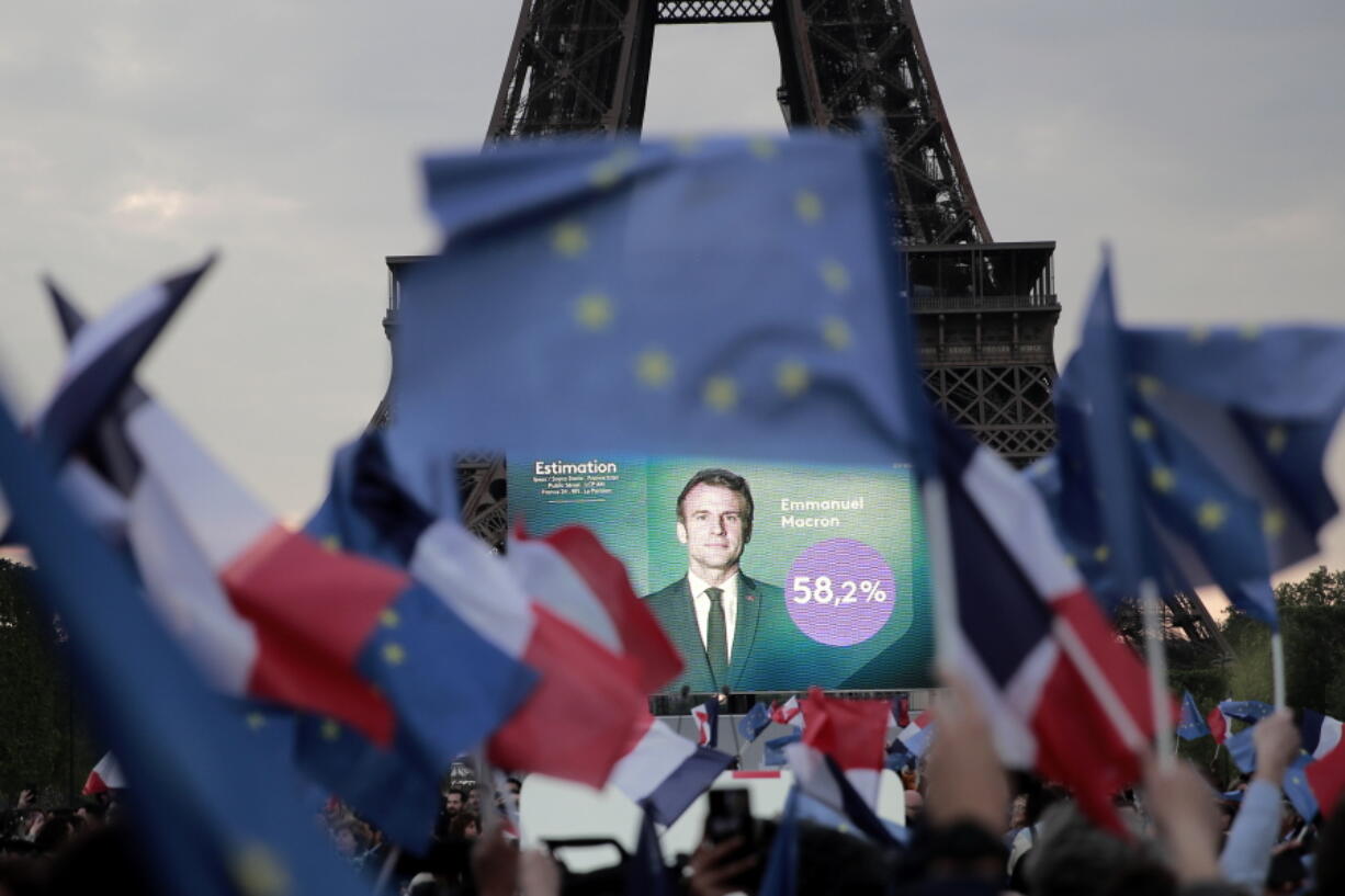 Supporters of French President Emmanuel Macron celebrate reports of his victory Sunday, April 24, 2022 in Paris. French President Emmanuel Macron appeared to comfortably win reelection Sunday in a runoff, polling agencies projected, offering France and the European Union the reassurance of leadership stability in the bloc's only nuclear-armed power as the continent grapples with the fallout from Russia's invasion of Ukraine.