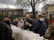 Rabbi Yehuda Teichtal, center, gives instructions April 7 during preparations for the celebration of Jewish Passover at the Chabad Jewish Education Center in Berlin, Germany. Rabbis and Jewish organizations are working around the clock within Ukraine and other parts of Europe to make sure that Jews who remain in Ukraine and refugees who have fled are able to celebrate Passover.