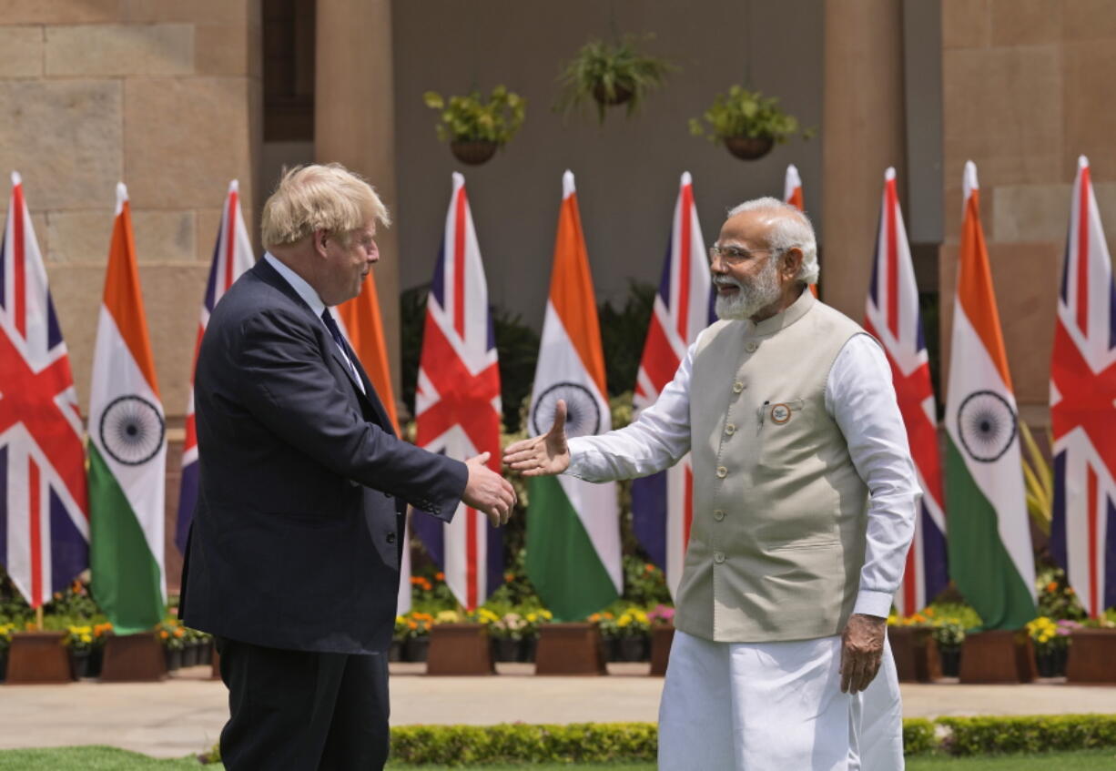 Indian Prime Minister Narendra Modi shakes hand with his British counterpart Boris Johnson before their delegation level talks in New Delhi, Friday, April 22, 2022. Johnson is expected to help move India away from its dependence on Russia by expanding economic and defense ties when he meets with his Indian counterpart Friday, officials said.