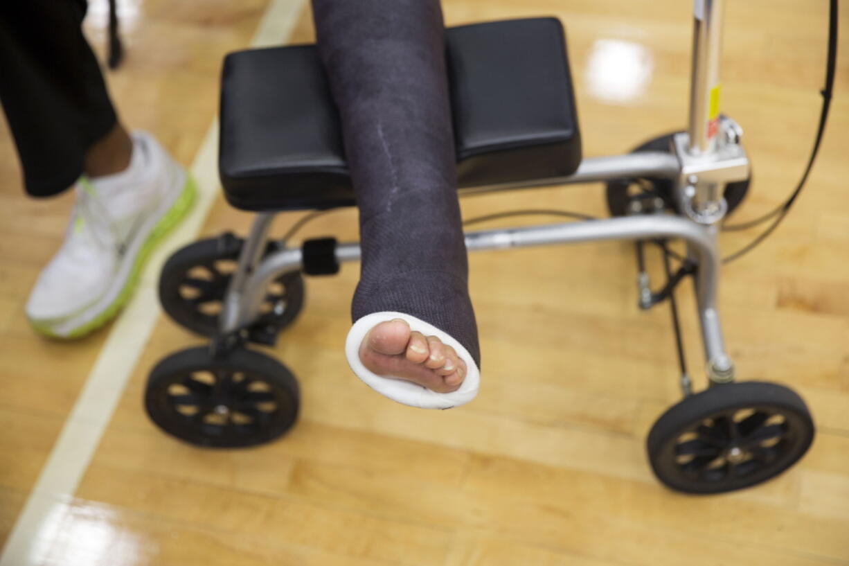 Georgia State head basketball coach Ron Hunter has his foot in a cast as he talks to the media 2015 in Atlanta. Hunter had a torn Achilles tendon.