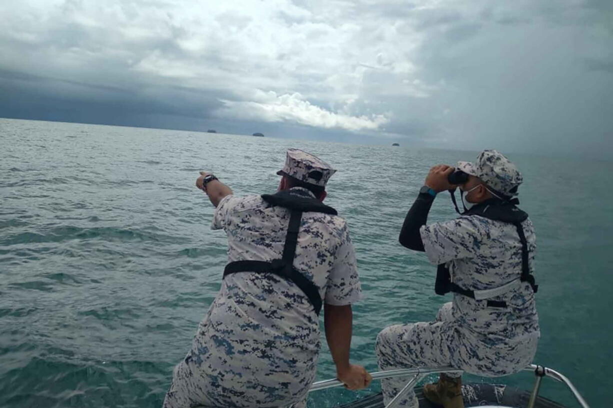 This photo released by the Malaysian Maritime Enforcement Agency (MMEA) on Friday, April 8, 2022, shows search and rescue operation for foreign divers off the coast of Johor's Mersing, Malaysia. Two Europeans who disappeared during a dive last week have been rescued by fishermen, Malaysian authorities said Saturday, with the search operation now focused on finding a 14-year-old Dutch teen who remained missing.