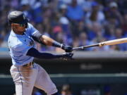 Seattle Mariners' Julio Rodriguez swings at a pitch against the Chicago Cubs during the third inning of a spring training baseball game Wednesday, March 30, 2022, in Mesa, Ariz. (AP Photo/Ross D.