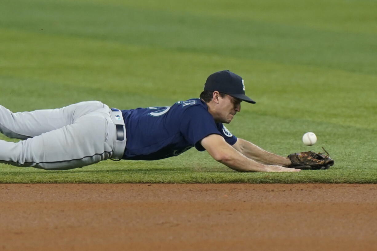 Seattle Mariners second baseman Adam Frazier is unable to catch a ball hit by Miami Marlins' Jesus Aguilar during the first inning Friday in Miami.