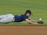 Seattle Mariners second baseman Adam Frazier is unable to catch a ball hit by Miami Marlins' Jesus Aguilar during the first inning Friday in Miami.