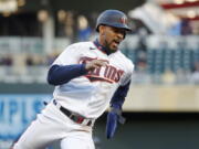 Minnesota Twins' Byron Buxton rounds third base en route to scoring against the Seattle Mariners on a double by Jorge Polanco in the first inning of a baseball game Monday, April 11, 2022, in Minneapolis.