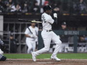 Chicago White Sox's Tim Anderson watches his two-run double during the second inning of the team's baseball game against the Seattle Mariners on Wednesday, April 13, 2022, in Chicago.