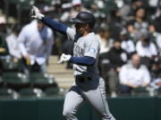 Seattle Mariners' Jarred Kelenic celebrates after hitting a two-run home run during the second inning of a baseball game against the Chicago White Sox Thursday, April 14, 2022, in Chicago.