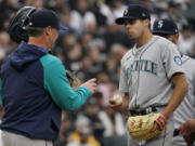 Seattle Mariners manager Scott Servais, left, takes the ball from starting pitcher Matt Brash during the sixth inning of the team's baseball game against the Chicago White Sox in Chicago, Tuesday, April 12, 2022. (AP Photo/Nam Y.