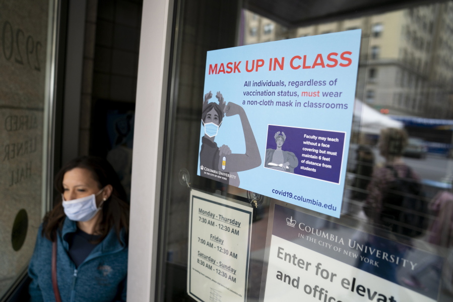 Signs indicating that protective face masks must be worn in classrooms are displayed outside lecture halls at Columbia University, Thursday, April 21, 2022, in the Manhattan borough of New York.