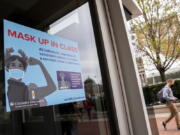 Signs indicating that protective face masks must be worn in classrooms are displayed outside lecture halls at Columbia University, Thursday, April 21, 2022, in the Manhattan borough of New York.