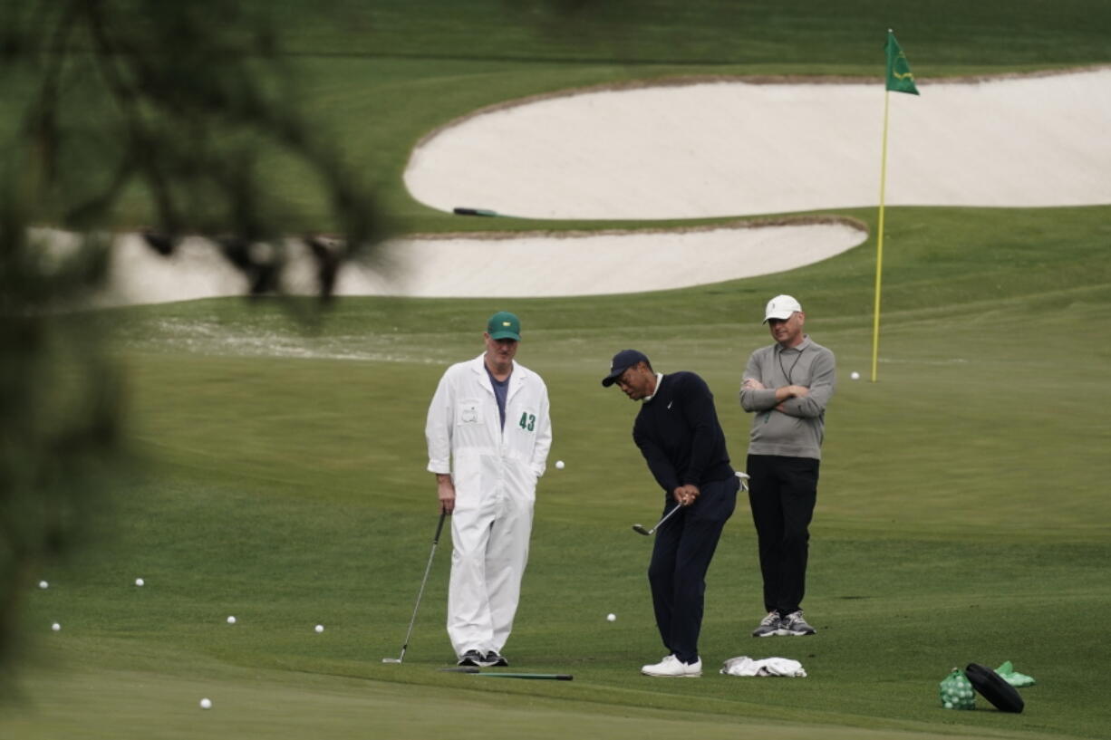 Tiger Woods hits on the driving range during a practice round for the Masters golf tournament on Tuesday, April 5, 2022, in Augusta, Ga.