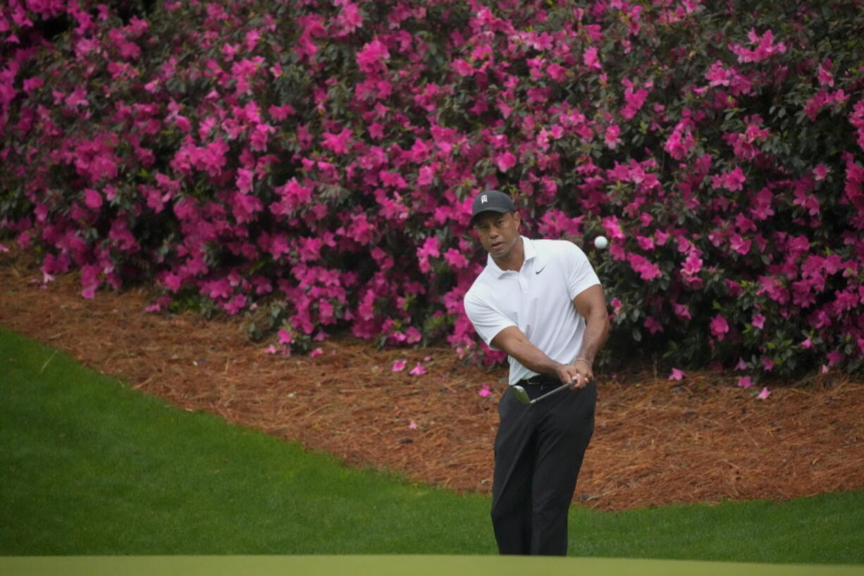 Tiger Woods chips to the green on the 13th hole during a practice round for the Masters golf tournament on Wednesday, April 6, 2022, in Augusta, Ga.