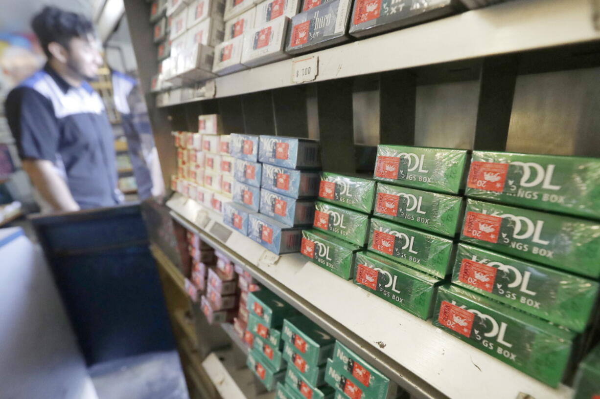 FILE - This May 17, 2018 file photo shows packs of menthol cigarettes and other tobacco products at a store in San Francisco.   As federal officials finalize a long-awaited plan to ban menthol cigarettes, dozens of interest groups have met with White House staffers to try and influence the process, which has the potential to save thousands of lives while wiping out billions in tobacco sales.