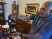 Bob Guerra, a Catholic deacon, holds a crucifix he got to commemorate the visit of Pope Francis to the U.S.-Mexican border at his house April 3 in El Paso, Texas.