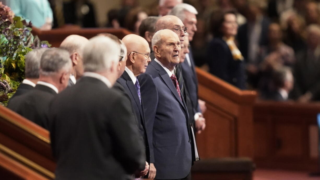 The Church of Jesus Christ of Latter-day Saints President Russell M. Nelson, center, looks on during The Church of Jesus Christ of Latter-day Saints' twice-annual church conference Saturday, April 2, 2022, in Salt Lake City. Top leaders are expected to deliver speeches to 10,000 in-person attendees for the first time since the onset of the coronavirus pandemic.