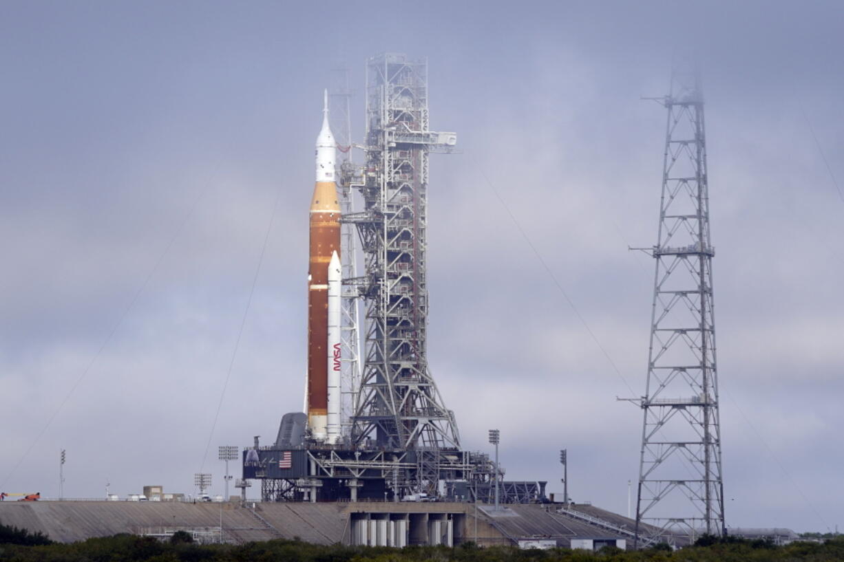 FILE -The NASA Artemis rocket with the Orion spacecraft aboard stands on pad 39B at the Kennedy Space Center in Cape Canaveral, Fla., Friday, March 18, 2022. NASA is kicking off a critical countdown test for its new moon rocket. The two-day dress rehearsal began Friday, April 1, 2022 at Florida's Kennedy Space Center and will culminate Sunday with the loading of the rocket's fuel tanks.