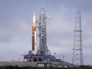 FILE -The NASA Artemis rocket with the Orion spacecraft aboard stands on pad 39B at the Kennedy Space Center in Cape Canaveral, Fla., Friday, March 18, 2022. NASA is kicking off a critical countdown test for its new moon rocket. The two-day dress rehearsal began Friday, April 1, 2022 at Florida's Kennedy Space Center and will culminate Sunday with the loading of the rocket's fuel tanks.