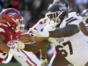 FILE - Mississippi State offensive lineman Charles Cross (67) blocks against Arkansas during an NCAA college football game Nov. 6, 2021, in Fayetteville, Ark. Cross was selected by the Seattle Seahawks during the first round of the NFL draft Thursday, April 28.