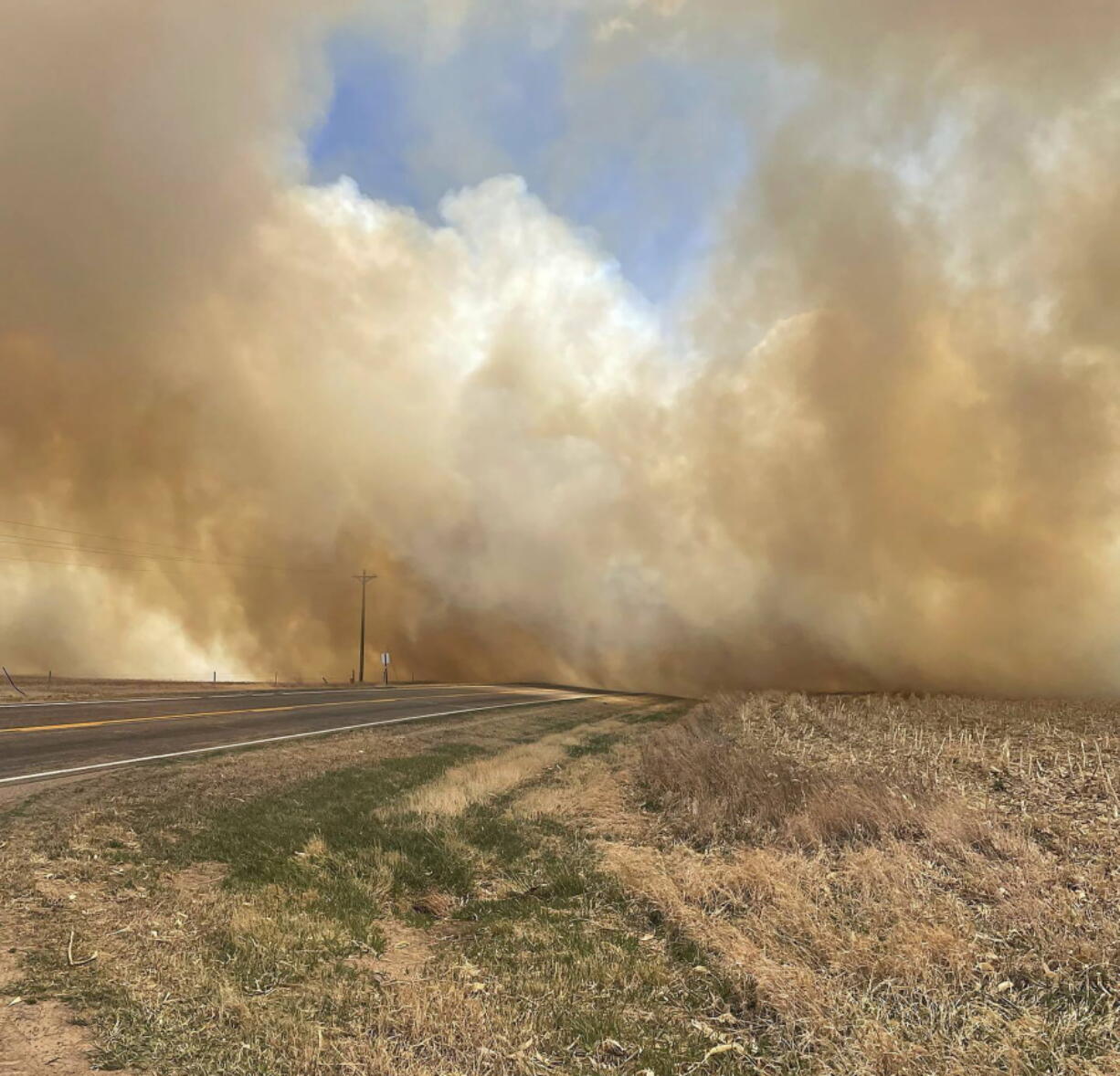 This image provided by the Nebraska State Patrol shows smoke from a wildfire, Saturday, April 23, 2022 near Cambridge, Neb. Several small towns, including Cambridge, Bartley, Indianola and Wilsonville, in Nebraska's southwest and Macy in its northeast, were forced to temporarily evacuate because of the wind-driven wildfires.