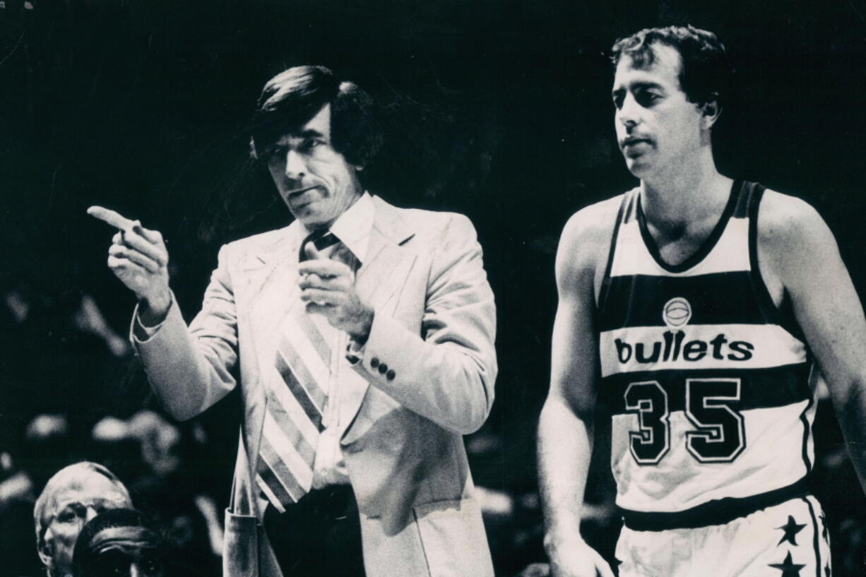 Baltimore Bullets coach Gene Shue motions to the bench in this 1980 photo. At right is Bullets' Kevin Grevey (35). Shue, a two-time NBA Coach of the Year who won 784 games with the Bullets, 76ers and Clippers, has died. He was 90. The Wizards and the NBA announced Shue's death Monday, April 4, 2021. (Irving H.