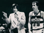 Baltimore Bullets coach Gene Shue motions to the bench in this 1980 photo. At right is Bullets' Kevin Grevey (35). Shue, a two-time NBA Coach of the Year who won 784 games with the Bullets, 76ers and Clippers, has died. He was 90. The Wizards and the NBA announced Shue's death Monday, April 4, 2021. (Irving H.