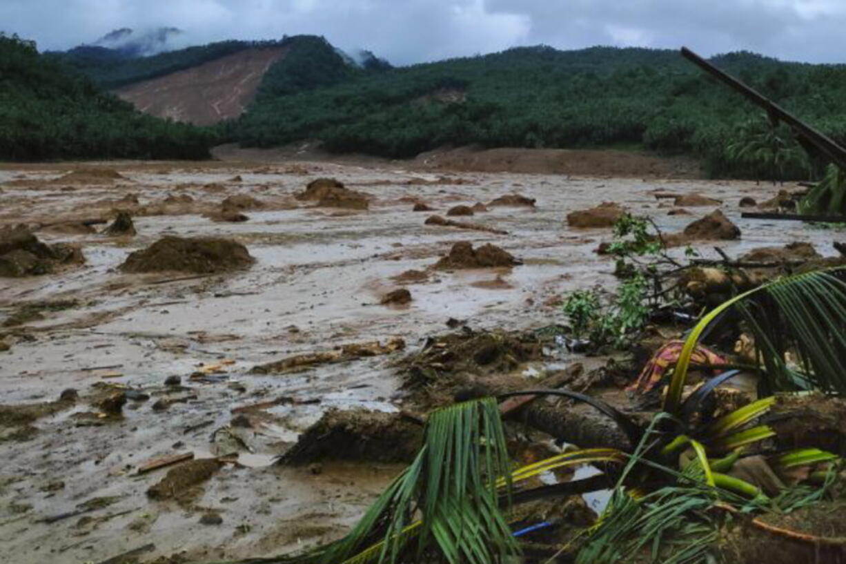 This photo provided by the Philippine Coast Guard, shows a landslide area at Baybay City, Leyte province, central Philippines Monday, April 11, 2022. Heavy rains caused by a summer tropical depression killed at least several people in the central and southern Philippines, mostly due to landslides, officials said Monday.