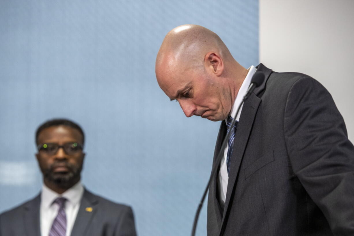 Grand Rapids Police Chief Eric Winstrom, right, and Grand Rapids City Manager Mark Washington react as a TV display shows video evidence of a Grand Rapids police officer struggling with and shooting Patrick Lyoya at Grand Rapids City Hall on Wednesday, April 13, 2022. Lyoya, 26, was shot and killed about 8:10 a.m., on April 4, after what police said was a traffic stop.