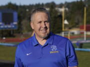 Joe Kennedy, a former assistant football coach at Bremerton High School in Bremerton, Wash., poses for a photo March 9, 2022, at the school's football field. After losing his coaching job for refusing to stop kneeling in prayer with players and spectators on the field immediately after football games, Kennedy will take his arguments before the U.S. Supreme Court on Monday, April 25, 2022, saying the Bremerton School District violated his First Amendment rights by refusing to let him continue praying at midfield after games. (AP Photo/Ted S.