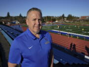 Joe Kennedy, a former assistant football coach at Bremerton High School in Bremerton, Wash., poses for a photo March 9, 2022, at the school's football field. After losing his coaching job for refusing to stop kneeling in prayer with players and spectators on the field immediately after football games, Kennedy will take his arguments before the U.S. Supreme Court on Monday, April 25, 2022, saying the Bremerton School District violated his First Amendment rights by refusing to let him continue praying at midfield after games. (AP Photo/Ted S.