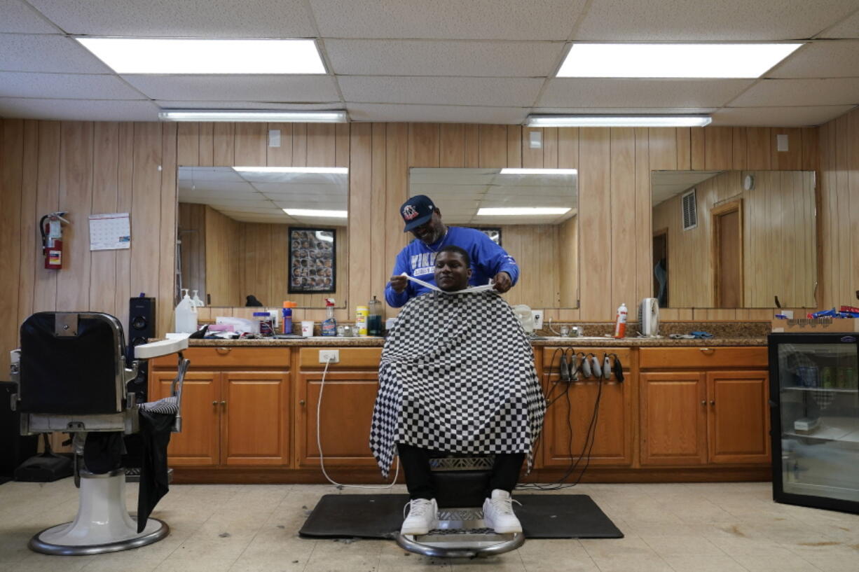 William Johnson cuts hair at Bridgers Barber shop in Princeville, N.C., Thursday, March 10, 2022. The barber shop is one of only a few businesses in the small community that was established by freed slaves.