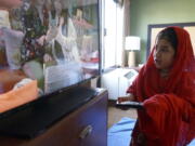 Sana Sultani, 8, watches children's programming on television in the motel room she shares with her parents and five siblings in El Paso, Texas, on Saturday, March 26, 2022. The Sultanis, one family among thousands of Afghans evacuated to the United States as the Taliban regained power last summer, moved into a duplex just in time to celebrate their first Muslim holy month of Ramadan in the U.S.