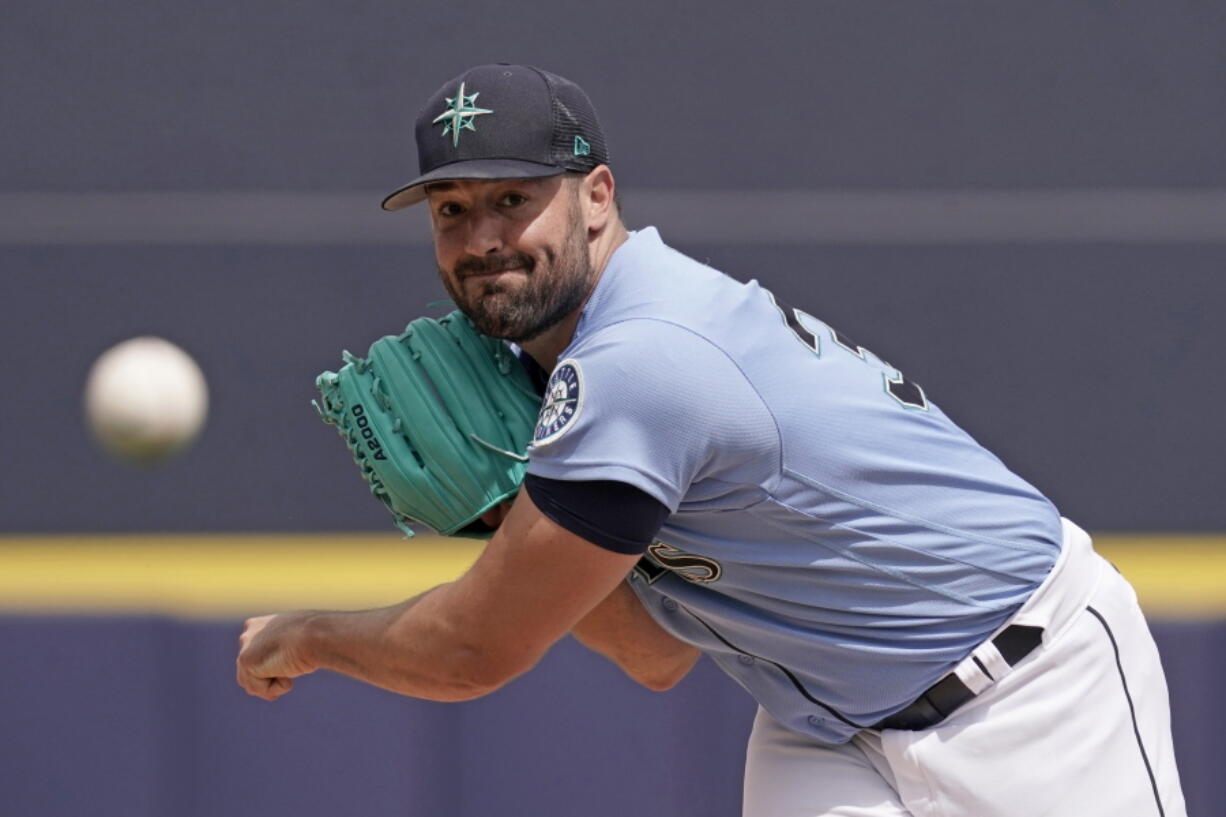 Seattle Mariners starting pitcher Robbie Ray throws during the first inning of a spring training baseball game against the Texas Rangers Monday, March 28, 2022, in Peoria, Ariz.