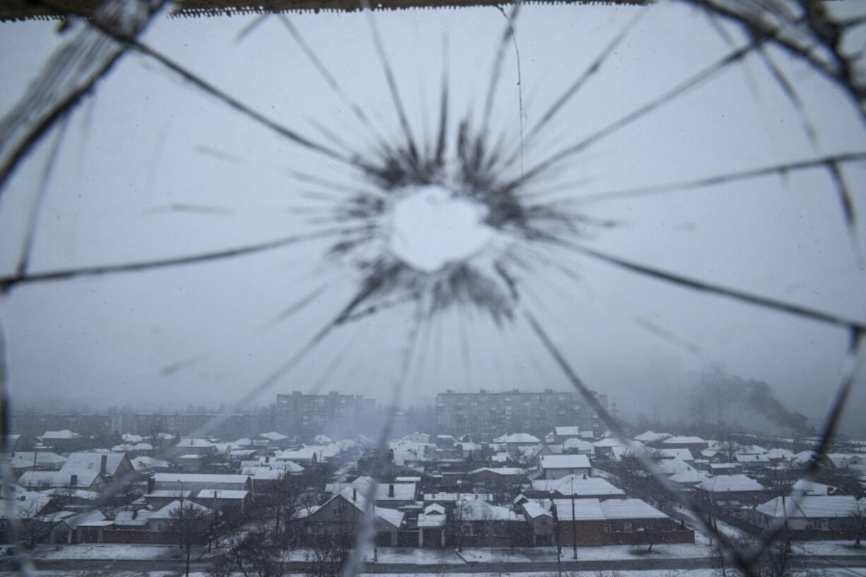 FILE - A hospital window is cracked from shelling in Mariupol, Ukraine, Thursday, March 3, 2022. Russia began evacuating its embassy in Kyiv, and Ukraine urged its citizens to leave Russia. Unbroken by a Russian blockade and relentless bombardment, the key port of Mariupol is still holding out, a symbol of staunch Ukrainian resistance that has thwarted the Kremlin's invasion plans.