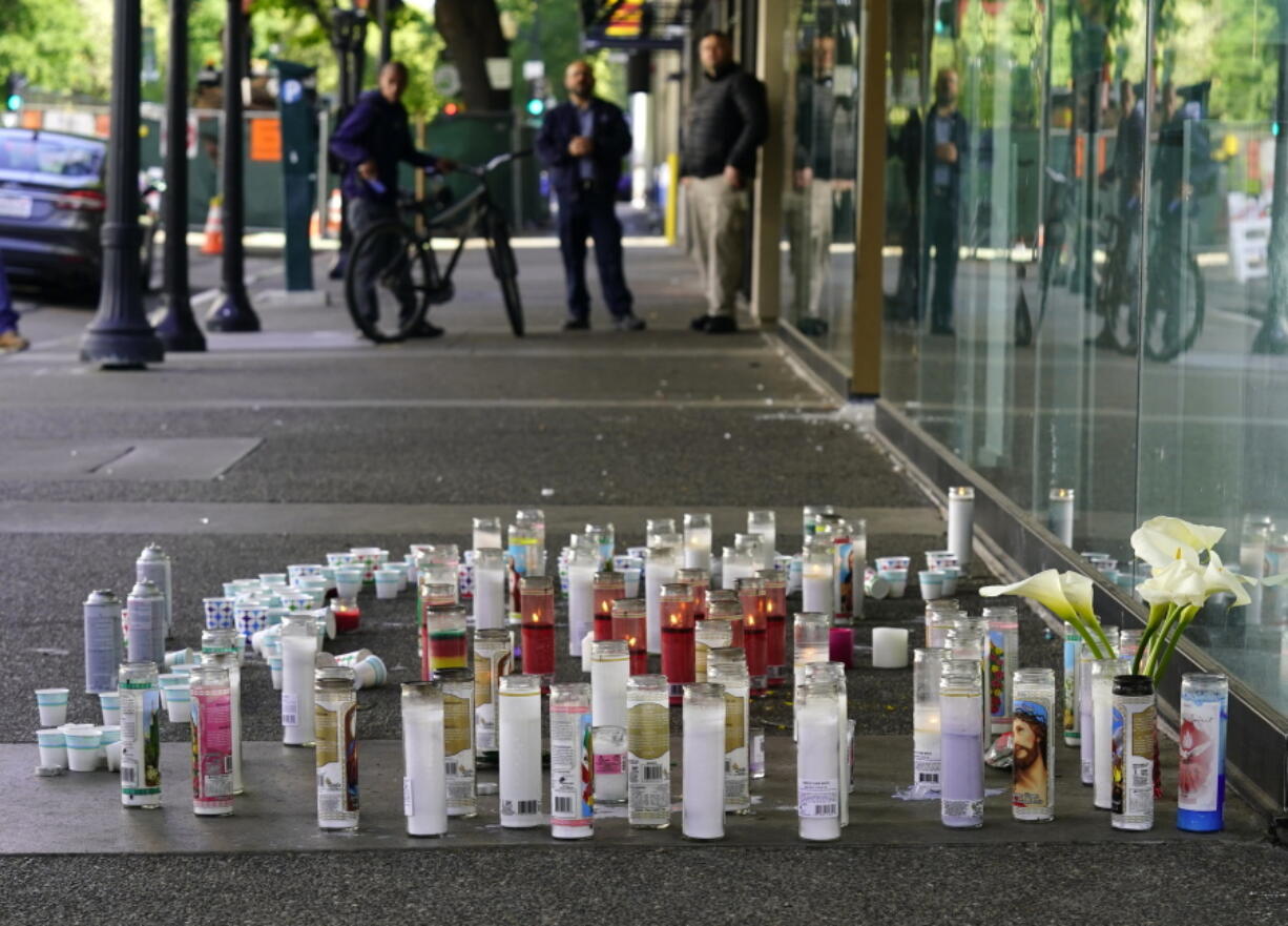 Candles and flowers make up a memorial, Tuesday, April 5,2022, at a memorial for those killed and injured in a mass shooting on April 3, 2022, in Sacramento, Calif. Dandrae Martin, who is facing charges connected to Sundays mass shooting, made his first court appearance in Sacramento County Superior Court, Tuesday. Martin, 26, was arrested as a "related suspect," on charges of assault with deadly weapon and being a convict carrying a loaded gun.