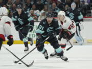 Seattle Kraken right wing Daniel Sprong (91) skates in front of Ottawa Senators left wing Parker Kelly (45) during the second period of an NHL hockey game, Monday, April 18, 2022, in Seattle. (AP Photo/Ted S.