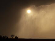 Storms approach Blair, Neb., looking west on State Highway 91 as the sun starts to set on Tuesday, April 12, 2022.